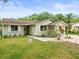 Inviting single-story home with neatly landscaped yard and pathway leading to the front door at 16116 Manorwood Cir, Tampa, FL 33624