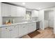 Beautiful kitchen with white cabinets, marble countertops and modern stainless steel appliances at 16116 Manorwood Cir, Tampa, FL 33624