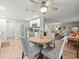 Open kitchen and living area with modern ceiling fan and stainless steel refrigerator at 16116 Manorwood Cir, Tampa, FL 33624