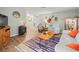 Bright living room featuring modern decor, wood-style flooring, and comfortable seating at 16116 Manorwood Cir, Tampa, FL 33624