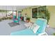 Relaxing screened porch featuring stylish lounge chair, dining set, and views of the landscaped backyard at 16116 Manorwood Cir, Tampa, FL 33624
