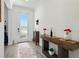 Bright foyer featuring wood-look tile flooring, a console table, and a glass-paneled front door at 17403 Holly Well Ave, Wimauma, FL 33598