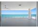 Open-air balcony with ceiling fan offers views of the blue ocean and beach at 19816 Gulf Blvd # 602, Indian Shores, FL 33785