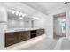 Bathroom boasts dual sink vanity, tile floor, modern lighting, and walk-in closet access at 19816 Gulf Blvd # 602, Indian Shores, FL 33785