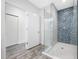 Modern bathroom with a glass enclosed shower featuring blue mosaic tile and dual shower heads at 19816 Gulf Blvd # 602, Indian Shores, FL 33785