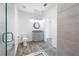 Bright bathroom with a glass-enclosed shower and vanity with a decorative mirror at 19816 Gulf Blvd # 602, Indian Shores, FL 33785