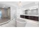 Primary bathroom featuring an over sized tub, double vanity and walk-in shower at 19816 Gulf Blvd # 602, Indian Shores, FL 33785