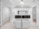 Bright primary bathroom with stand alone tub, double vanity and hardwood flooring at 19816 Gulf Blvd # 602, Indian Shores, FL 33785