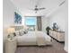 Bright bedroom with a ceiling fan, large window, and tastefully selected furniture at 19816 Gulf Blvd # 602, Indian Shores, FL 33785
