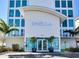 Striking building entrance featuring modern architecture, clear glass doors, and palm tree accents at 19816 Gulf Blvd # 602, Indian Shores, FL 33785
