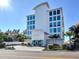 Modern building with bright white exterior, large impact windows and lush tropical landscaping at 19816 Gulf Blvd # 602, Indian Shores, FL 33785