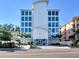 Contemporary building showcasing a clean white facade and large impact-resistant windows and lush landscaping at 19816 Gulf Blvd # 602, Indian Shores, FL 33785