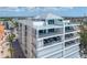 Exterior view of a modern luxury apartment building with multiple balconies overlooking the ocean at 19816 Gulf Blvd # 602, Indian Shores, FL 33785