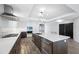 Modern kitchen with stainless steel appliances, center island and hardwood flooring at 19816 Gulf Blvd # 602, Indian Shores, FL 33785
