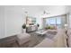 Bright living room with a ceiling fan, balcony access, and stylish furnishings at 19816 Gulf Blvd # 602, Indian Shores, FL 33785