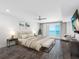 Bright bedroom features wood floors, ensuite, ceiling fan, and balcony with ocean view at 19816 Gulf Blvd # 602, Indian Shores, FL 33785