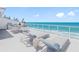 Relaxing rooftop deck with ocean view featuring outdoor dining and lounging in a bright, sunny setting at 19816 Gulf Blvd # 602, Indian Shores, FL 33785