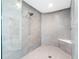 Walk-in shower with gray tiles, bench, and glass surround at 19816 Gulf Blvd # 602, Indian Shores, FL 33785
