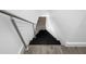 Modern staircase featuring sleek design, black stairs, and cable railing at 19816 Gulf Blvd # 602, Indian Shores, FL 33785