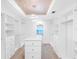 Walk-in closet with center island and custom shelving at 19816 Gulf Blvd # 602, Indian Shores, FL 33785