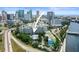 Aerial photo featuring a waterfront condo building surrounded by palm trees and city views at 201 W Laurel St # 307, Tampa, FL 33602