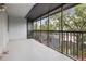 View of screened balcony overlooking trees and the street below at 201 W Laurel St # 307, Tampa, FL 33602