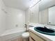 Bathroom with tiled bath, toilet, and basin at 201 W Laurel St # 307, Tampa, FL 33602