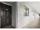 Hallway to the unit with a black front door, unit number 307, and textured walls at 201 W Laurel St # 307, Tampa, FL 33602