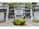 Condo entrance with unit #201 and garage doors surrounded by lush landscaping at 201 W Laurel St # 307, Tampa, FL 33602