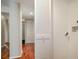 Hallway with white walls, white closet doors, and hardwood floors at 201 W Laurel St # 307, Tampa, FL 33602