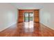 Spacious living room features hardwood floors and built-in shelving surrounding a sliding door to the balcony at 201 W Laurel St # 307, Tampa, FL 33602