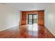 Spacious living room features hardwood floors and built-in shelving surrounding a sliding door to the balcony at 201 W Laurel St # 307, Tampa, FL 33602