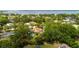 Aerial view showcases home with pool, surrounded by lush greenery in a waterfront community at 209 Arlington E Ave, Oldsmar, FL 34677