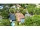Aerial view of home in lush neighborhood, boasting pool and proximity to other beautiful houses at 209 Arlington E Ave, Oldsmar, FL 34677