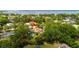 Aerial view showcases home with pool, surrounded by lush greenery in a waterfront community at 209 Arlington E Ave, Oldsmar, FL 34677