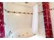 Bright bathroom featuring a large bathtub with massaging jets and a tiled surround at 209 Arlington E Ave, Oldsmar, FL 34677