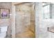 Bathroom with glass shower enclosure, neutral tile and modern fixtures for a relaxing and functional space at 209 Arlington E Ave, Oldsmar, FL 34677