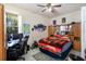 Cozy bedroom featuring a ceiling fan, large window, and neutral paint at 209 Arlington E Ave, Oldsmar, FL 34677