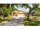 Inviting home featuring a spacious driveway, a two-car garage, and a neatly landscaped front yard at 209 Arlington E Ave, Oldsmar, FL 34677