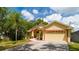 Inviting single-story home featuring a brick-lined walkway and manicured landscaping at 209 Arlington E Ave, Oldsmar, FL 34677