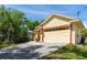 Side view of a home showcasing the two car garage with a paved driveway at 209 Arlington E Ave, Oldsmar, FL 34677