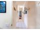 Hallway with tile flooring and decorated walls, leading to various rooms in the home at 209 Arlington E Ave, Oldsmar, FL 34677