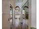 Hallway leading to bathroom showcasing mirrored closet doors and tile flooring for a cohesive design at 209 Arlington E Ave, Oldsmar, FL 34677