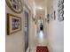 Hallway featuring light-colored walls and tile flooring leading to an office with a glass door at 209 Arlington E Ave, Oldsmar, FL 34677