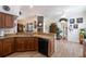 Well-equipped kitchen with granite countertops, wood cabinets, a stainless steel sink, and a black dishwasher at 209 Arlington E Ave, Oldsmar, FL 34677