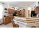 Charming kitchen with wooden cabinetry, granite countertops, and breakfast bar, seamlessly blending style with functionality at 209 Arlington E Ave, Oldsmar, FL 34677