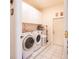 Bright laundry room featuring tile floors, appliances, and extra storage at 209 Arlington E Ave, Oldsmar, FL 34677
