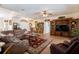 Open-concept living room featuring wood floors, a large leather sofa, and natural light at 209 Arlington E Ave, Oldsmar, FL 34677
