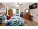 Main bedroom with hardwood floors and sliding glass doors leading to the pool area at 209 Arlington E Ave, Oldsmar, FL 34677