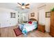 Bright main bedroom with tropical bedding, wood floors, four-poster bed, and ample natural light at 209 Arlington E Ave, Oldsmar, FL 34677